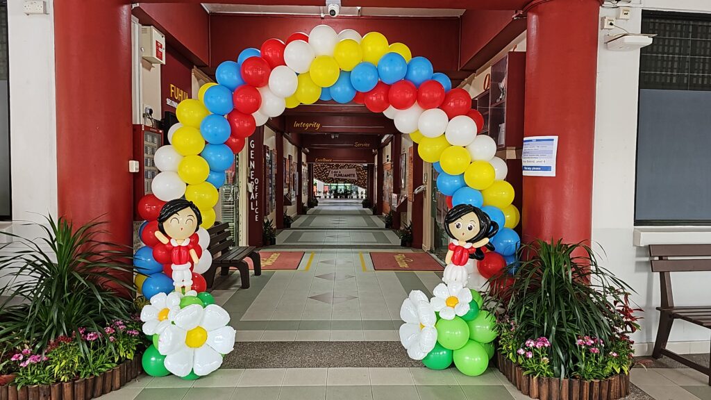 a balloon arch in a hallway