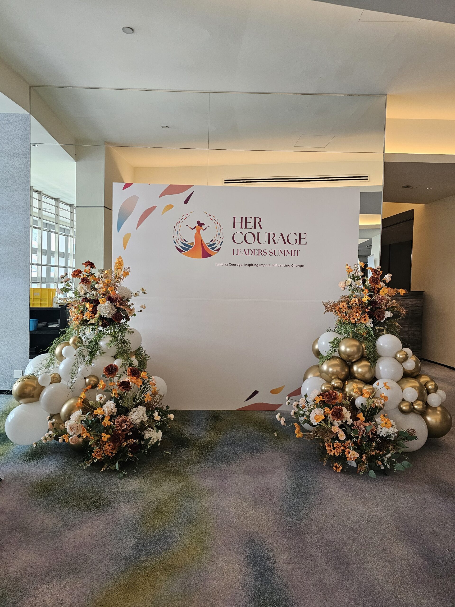 Elegant balloon backdrop Singapore styled with white gold balloons and florals