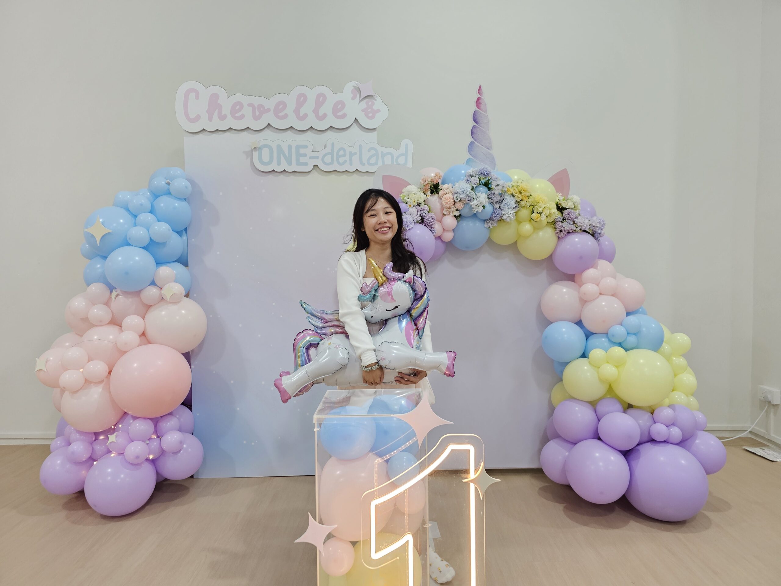 Pastel rainbow unicorn balloon decoration Singapore with ONE-derland themed backdrop
