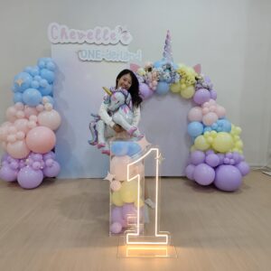 Pastel unicorn balloon decoration Singapore with rainbow arch and light-up number 1 for 1st birthday