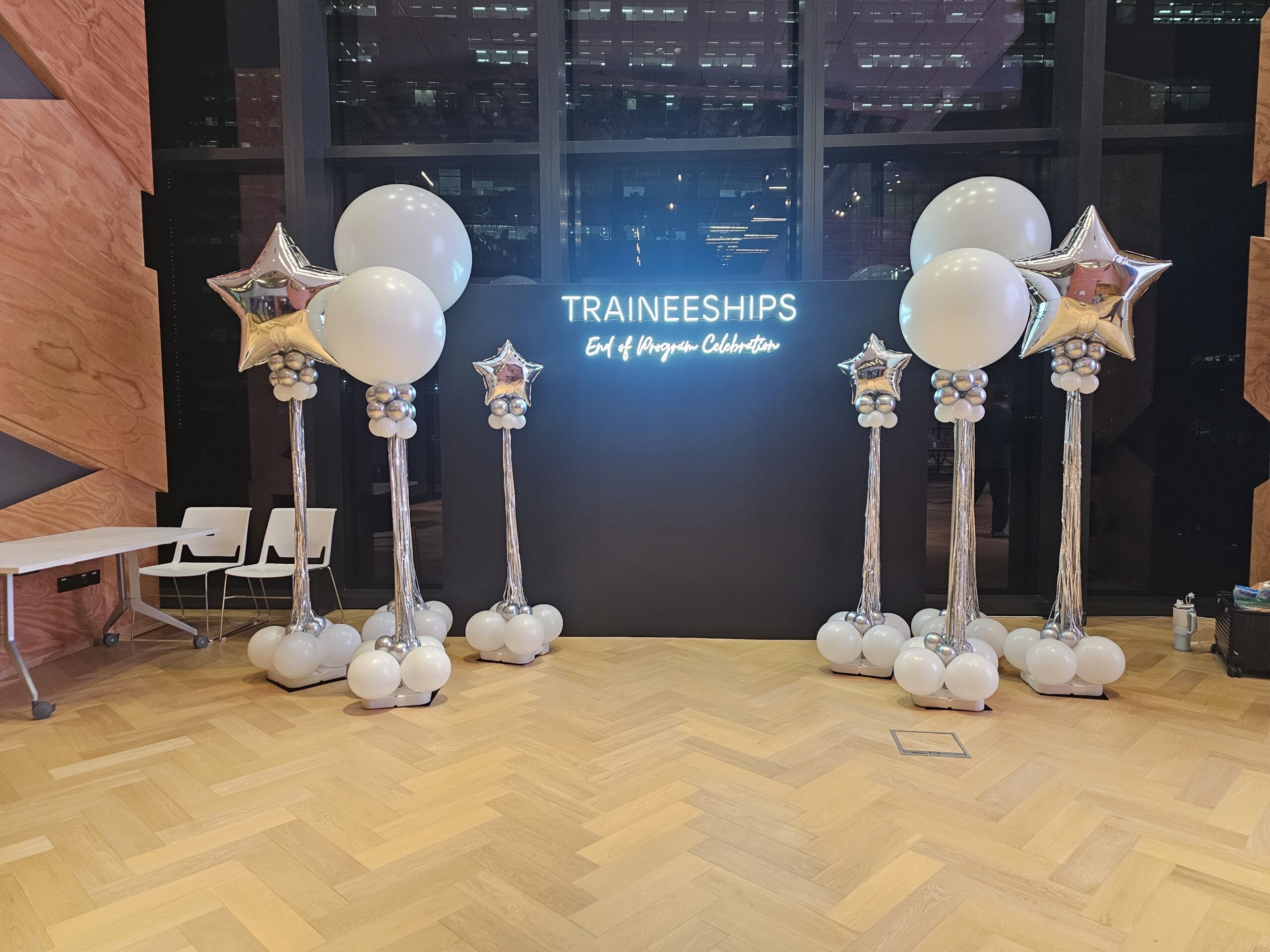 Silver balloon columns Singapore featuring star foil toppers for an elegant end-of-program event