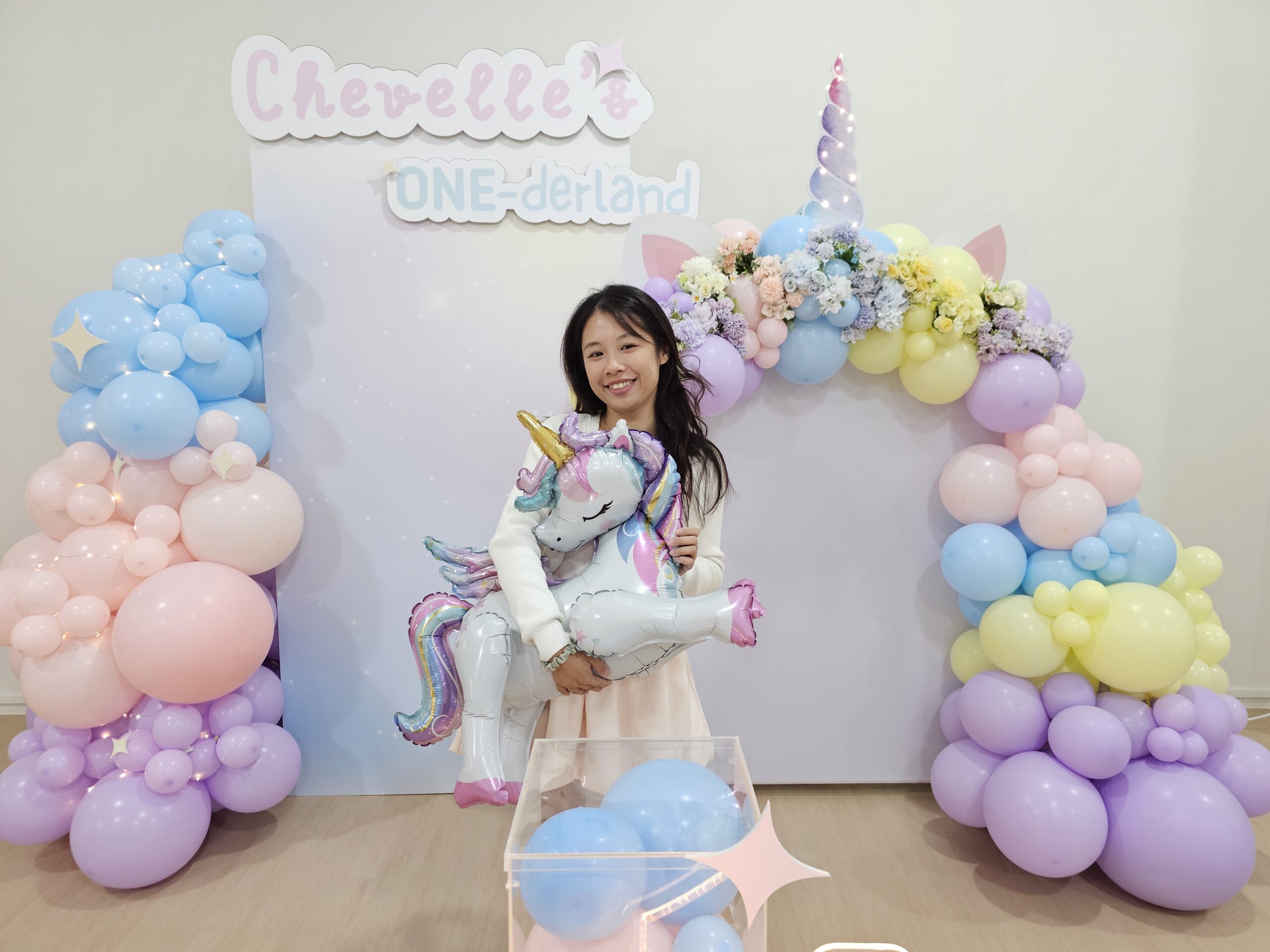 Unicorn balloon decoration Singapore featuring floral unicorn backdrop and pastel garland